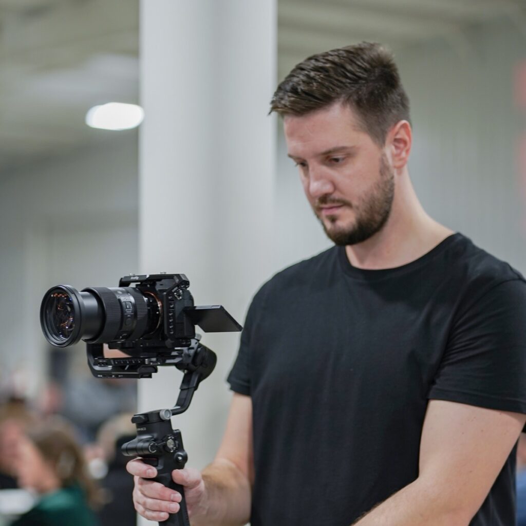 Oleg Kovalov operating a Sony camera on a DJI gimbal during a live event shoot